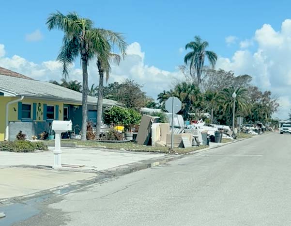 Debris from flood water by Hurricane Helene piled up on front yard
