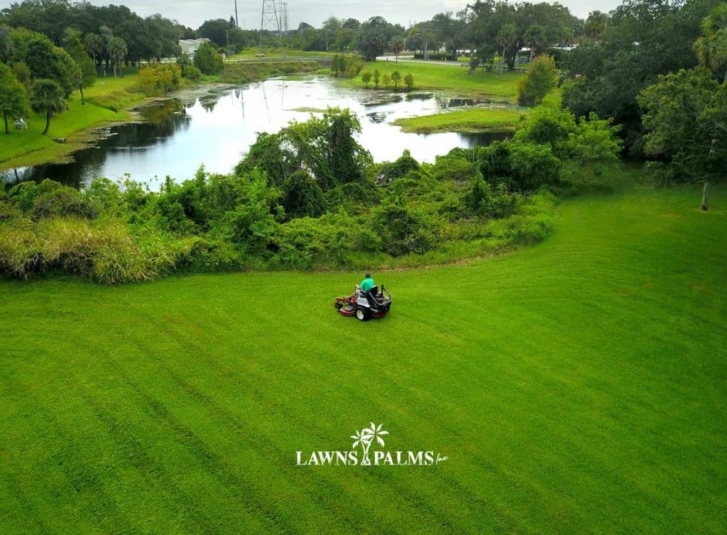 Riding mower in action at large commercial property